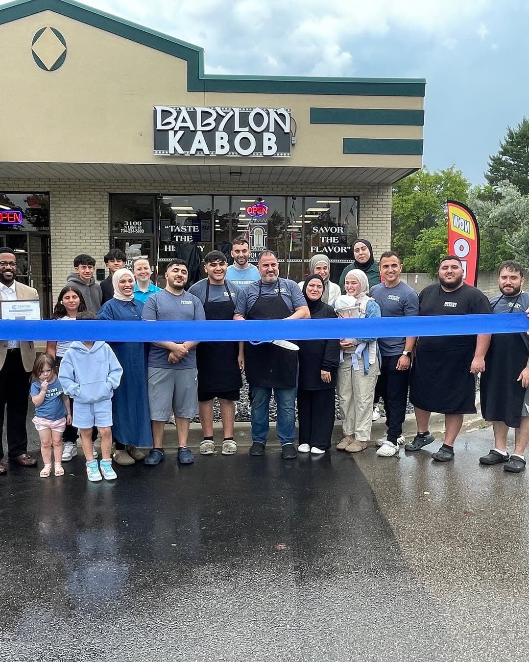 Grand opening ribbon cutting outside Babylon Kabob