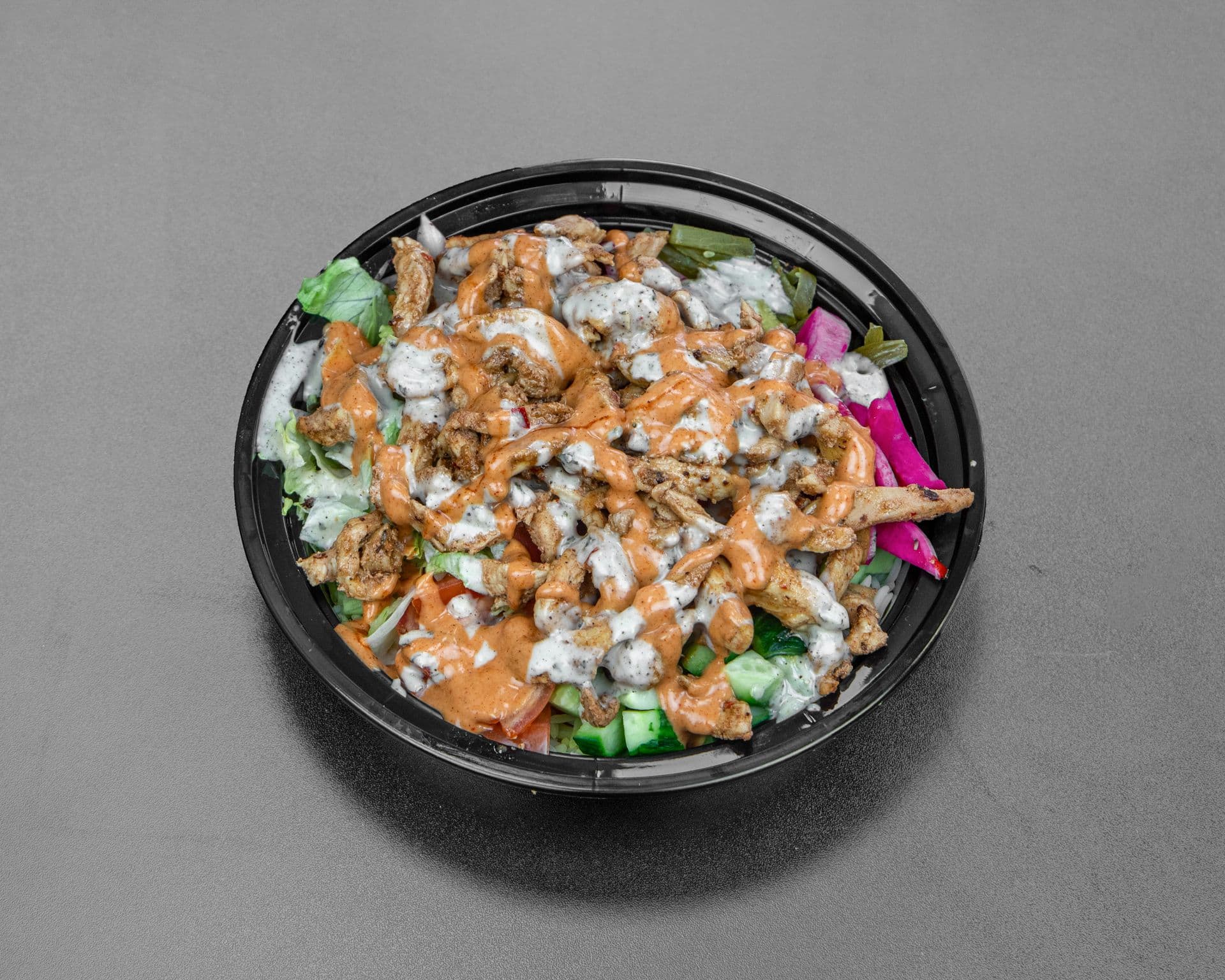Chicken rice bowl with salad and garlic sauce